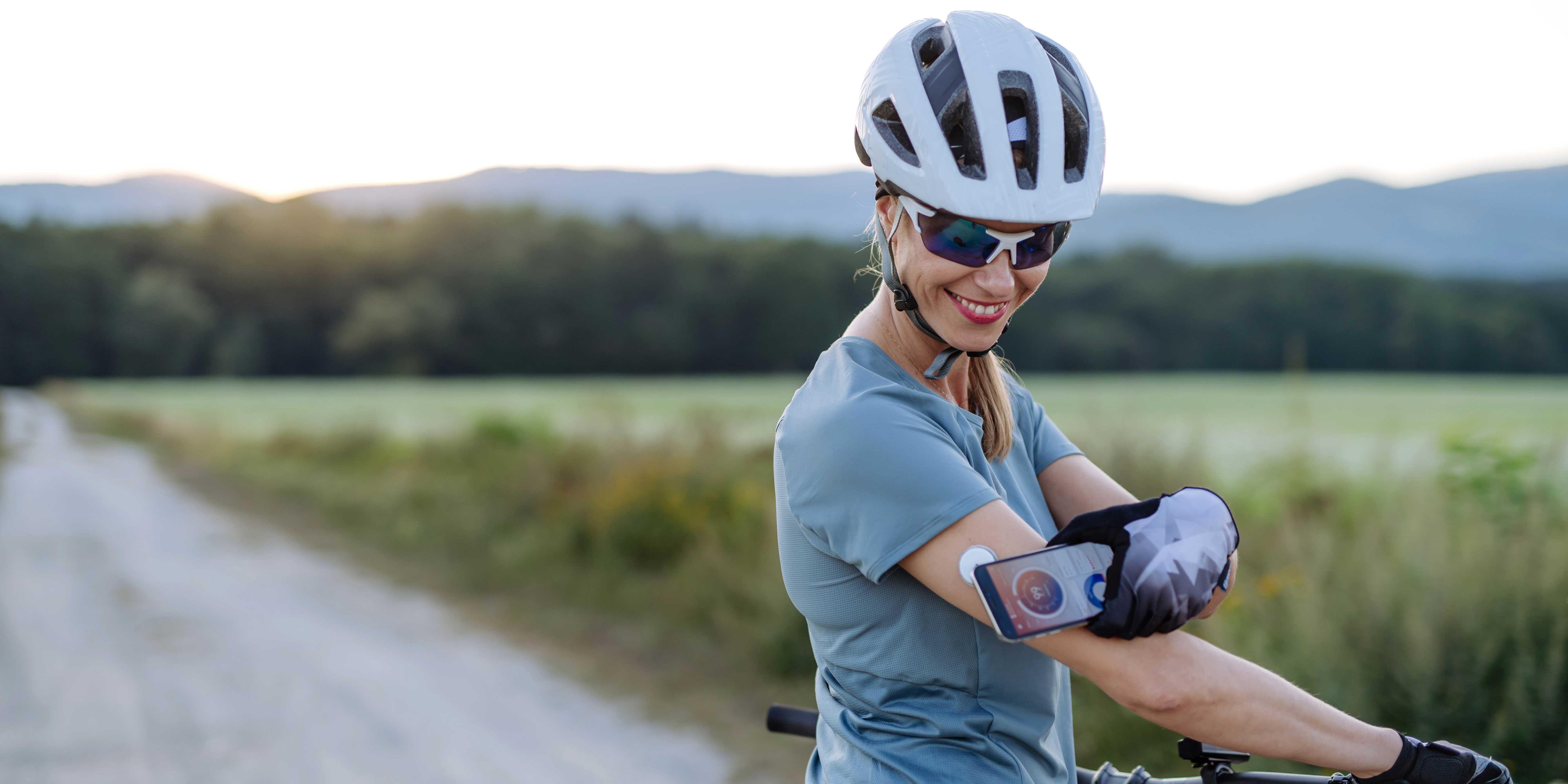 Woman attaches a blood glucose meter to her arm